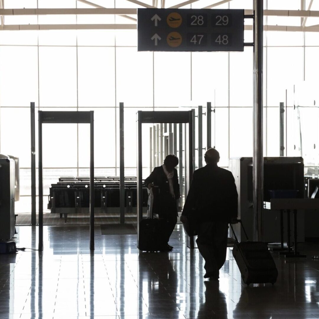 The Aeronautical Institute Two people walking through an airport terminal.